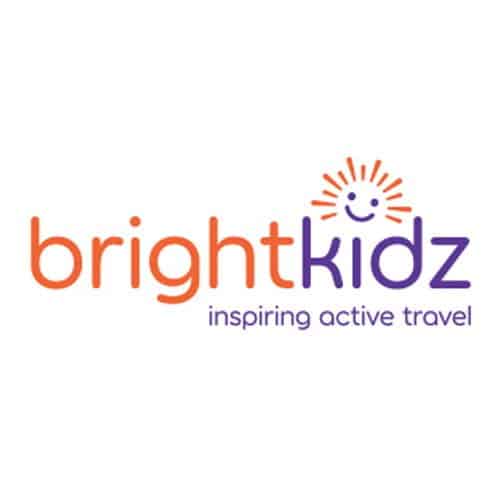 The Brightkidz logo with bright in orange, kidz in purple, a sun with a smiling face above the i, and the tagline inspiring active travel below in purple.