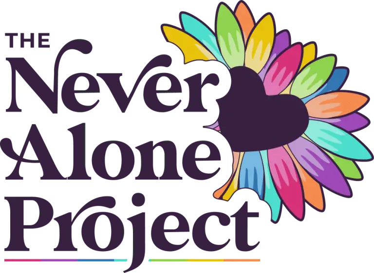 Logo for The Never Alone Project, featuring large dark text and a colourful, heart-shaped design made of multicoloured feathers or petals on the right side. A thin rainbow line appears underneath the text.